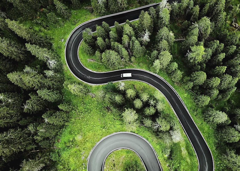 Aerial view of a curvy road in the woods