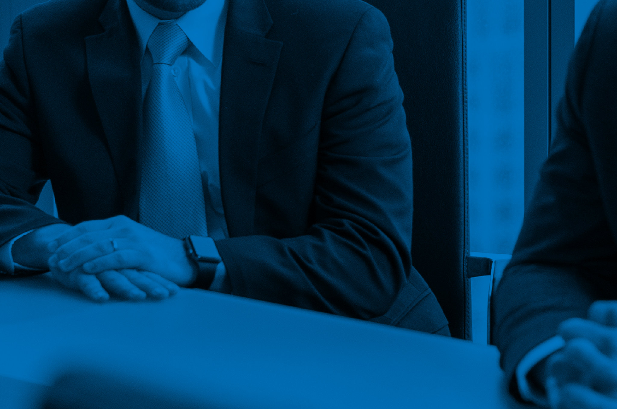 Closeup of someone sitting at a conference table